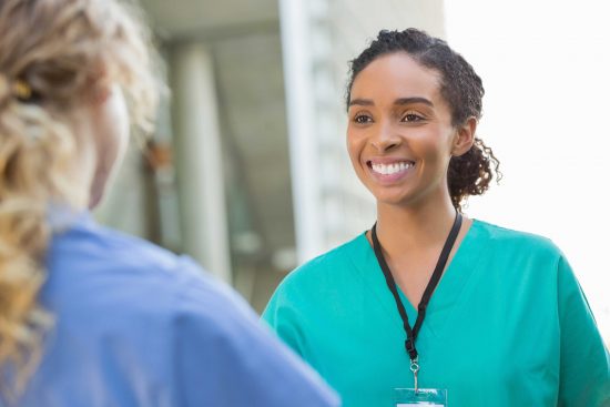 Student wearing scrubs in medical setting