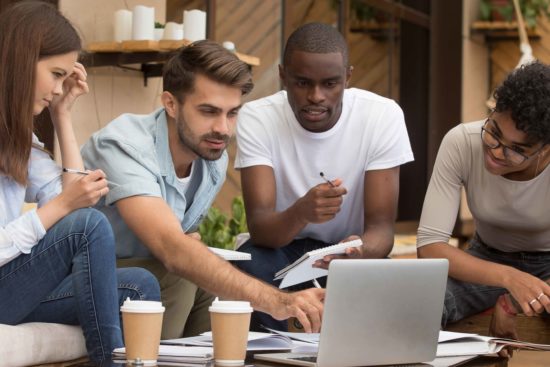 College students collaborating on laptop