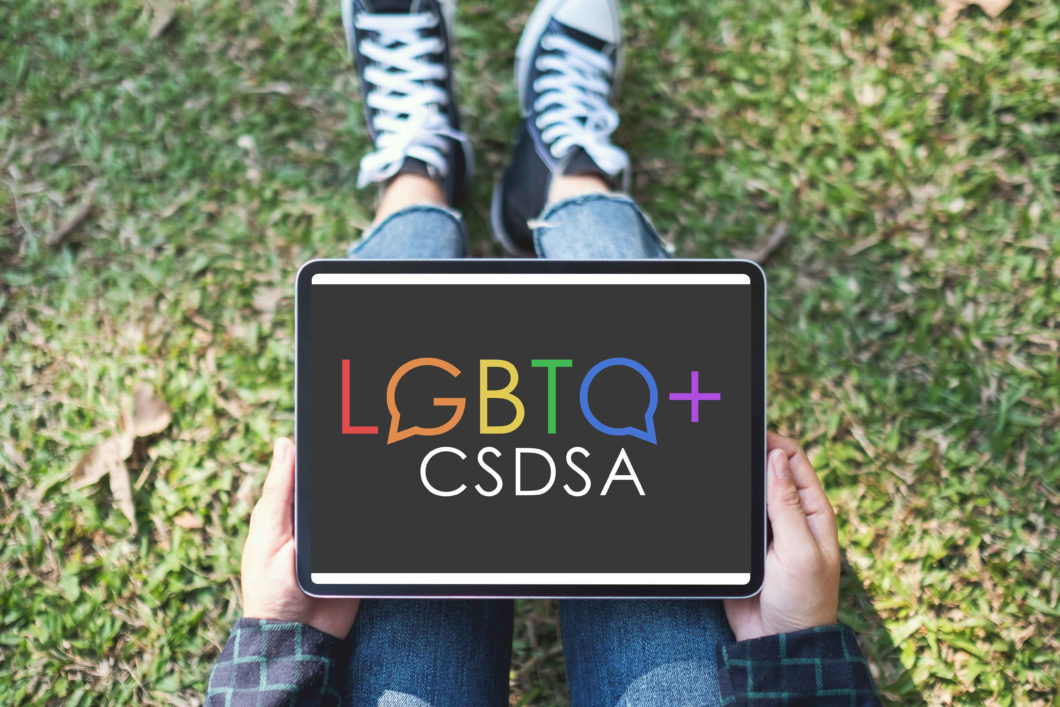 LGBTQCSDSA logo on ipad screen (student holding)